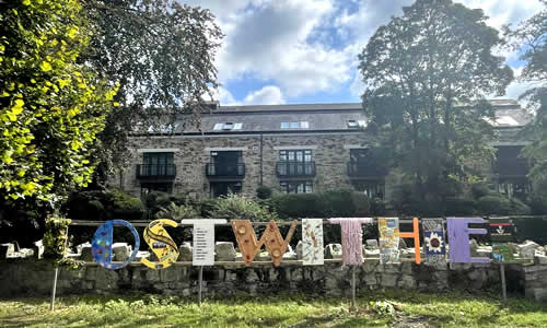 Lostwithiel sign by river bank